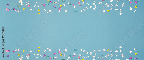 Wide banner with small wooden letters and numbers in two rows on blue background.
