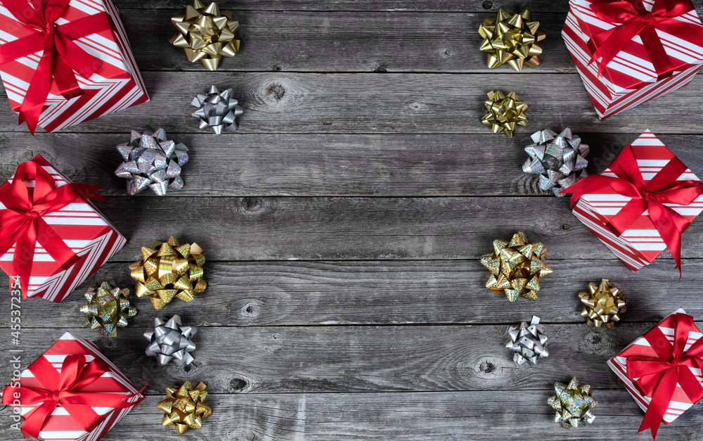 Obraz premium Giftboxes and bows on vintage wooden planks for a merry Christmas or happy New Year holiday celebration concept