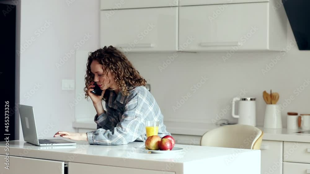 A close up portrait of an isolated beautiful girl with curly hair, typing on a laptop, wearing a plaid shirt. A close up portrait of an isolated beautiful girl with curly hair, typing on a laptop, wearing a plaid shirt.
