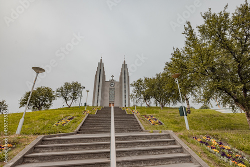 Church on the top of the hill in akureyri, iceland, a  big staircase leading to the church entrance. photo