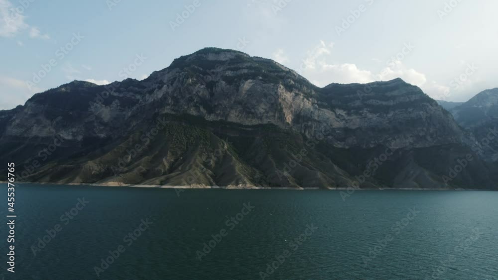 custom made wallpaper toronto digitalNatural landscape with a turquoise water reservoir and a huge mountain. Action. Calm blue river and a high hill on blue sky background.