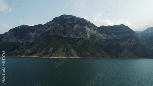 Wallpaper Mural Natural landscape with a turquoise water reservoir and a huge mountain. Action. Calm blue river and a high hill on blue sky background. Torontodigital.ca
