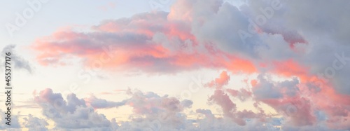 Clear blue sky, red, pink, golden cirrus and cumulus clouds after storm. Dramatic sunset cloudscape. Concept art, meteorology, heaven, hope, peace, graphic resources, picturesque panoramic scenery