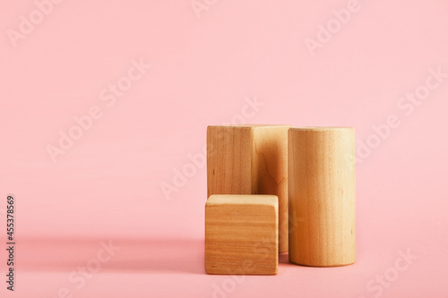 Fototapeta Naklejka Na Ścianę i Meble -  Wooden blocks podiums for goods on pink background. Geometric shapes for presentation of products, cosmetics...