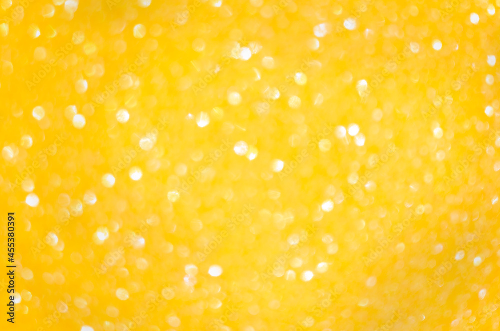 Blurred bokeh made of golden round circles. Abstract background
