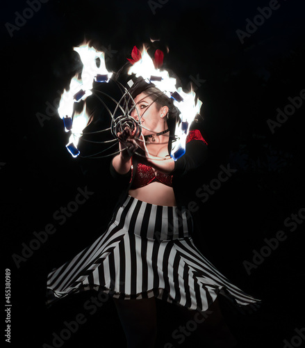 Women Performs in circus outfit with fire ring. 