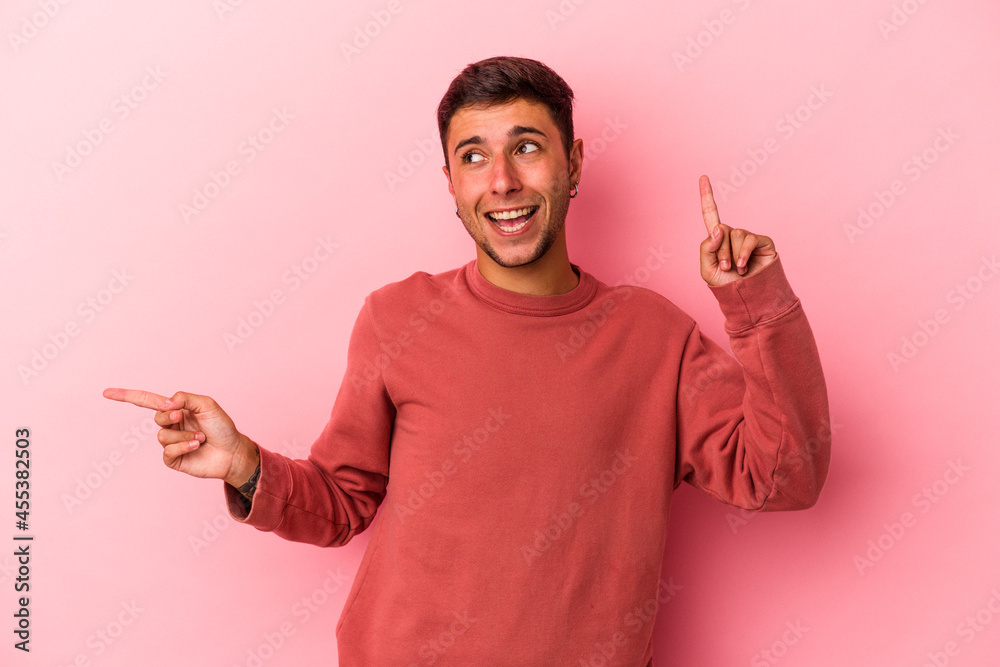 Young caucasian man with tattoos isolated on yellow background pointing to different copy spaces, choosing one of them, showing with finger. Young caucasian man with tattoos isolated on yellow background pointing to different copy spaces, choosing one of them, showing with finger.