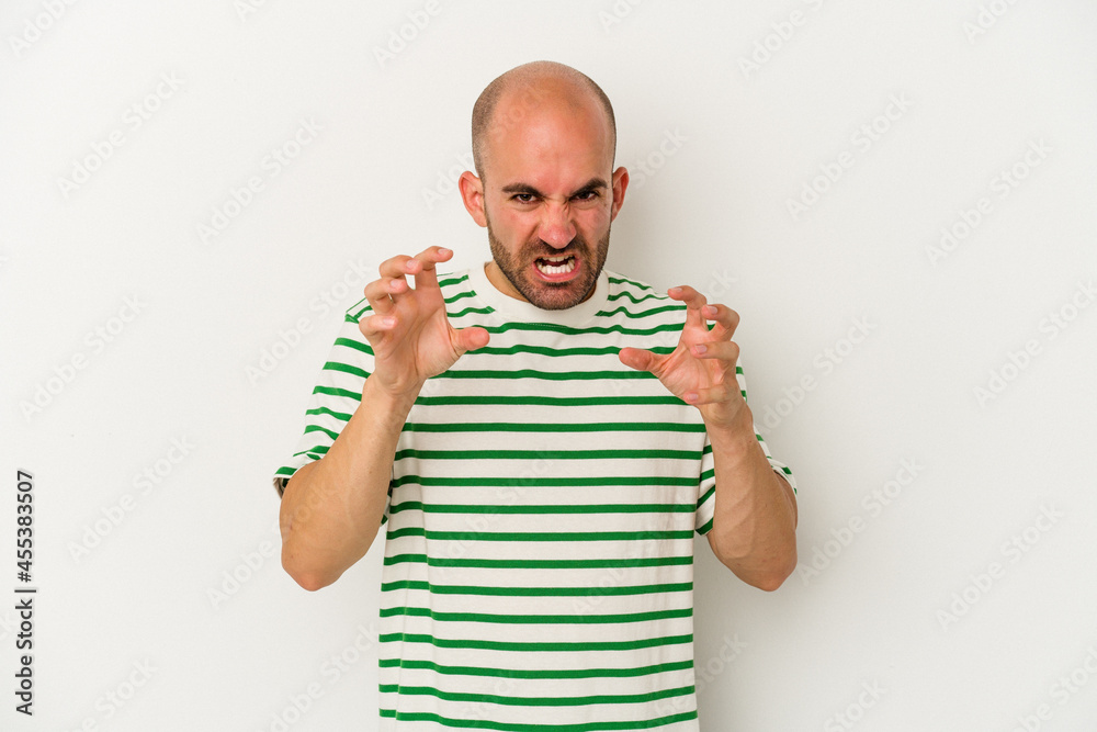 Naklejka premium Young bald man isolated on white background showing claws imitating a cat, aggressive gesture.