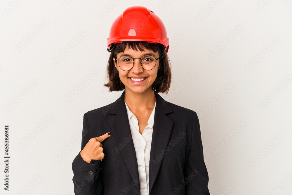 Young architect woman with red helmet isolated on white background person pointing by hand to a shirt copy space, proud and confident Young architect woman with red helmet isolated on white background person pointing by hand to a shirt copy space, proud and confident
