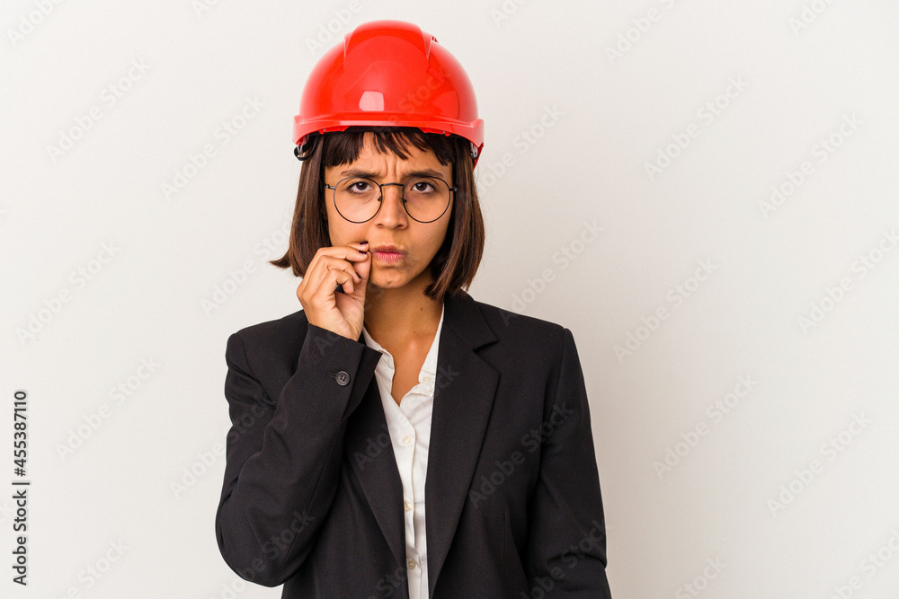 Young architect woman with red helmet isolated on white background with fingers on lips keeping a secret. Young architect woman with red helmet isolated on white background with fingers on lips keeping a secret.
