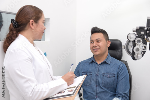 
Visual health problems of a Latino youth due to overexposure to computer screens and cell phones. An eye doctor examines the eyes