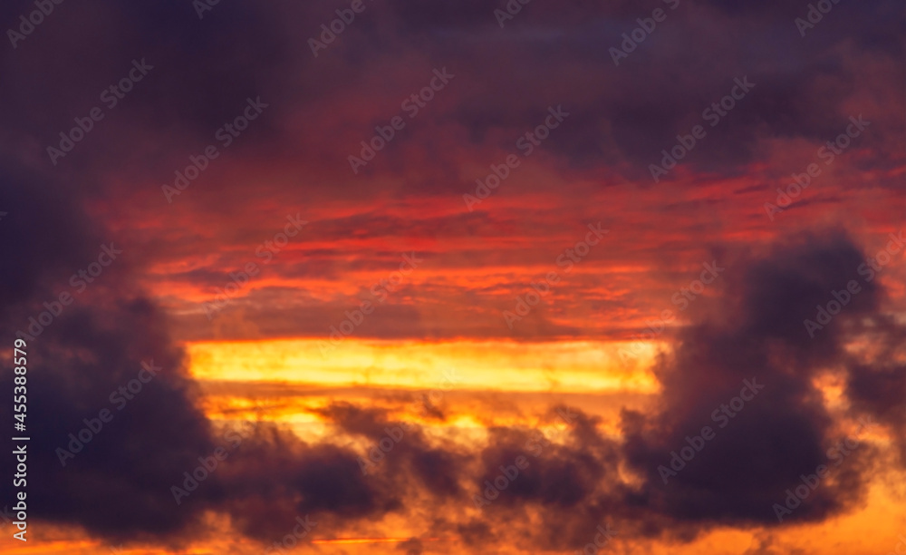 Bright sunset before the storm. Yellow and purple clouds at sunset, place for text, texture for background photo