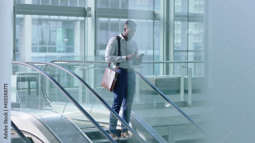 mixed race business woman using smartphone on escalator leaving work rushing texting checking messages female executive late for meeting in corporate office lobby 4k footage mixed race business woman using smartphone on escalator leaving work rushing texting checking messages female executive late for meeting in corporate office lobby 4k footage