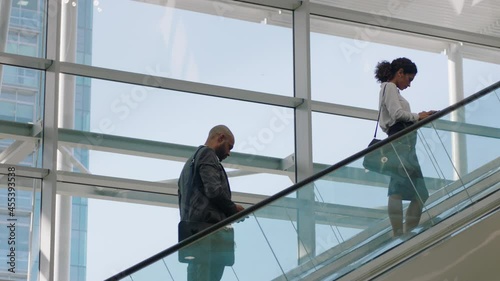 business people on escalators in busy corporate office lobby working nine to five rush 4k footage