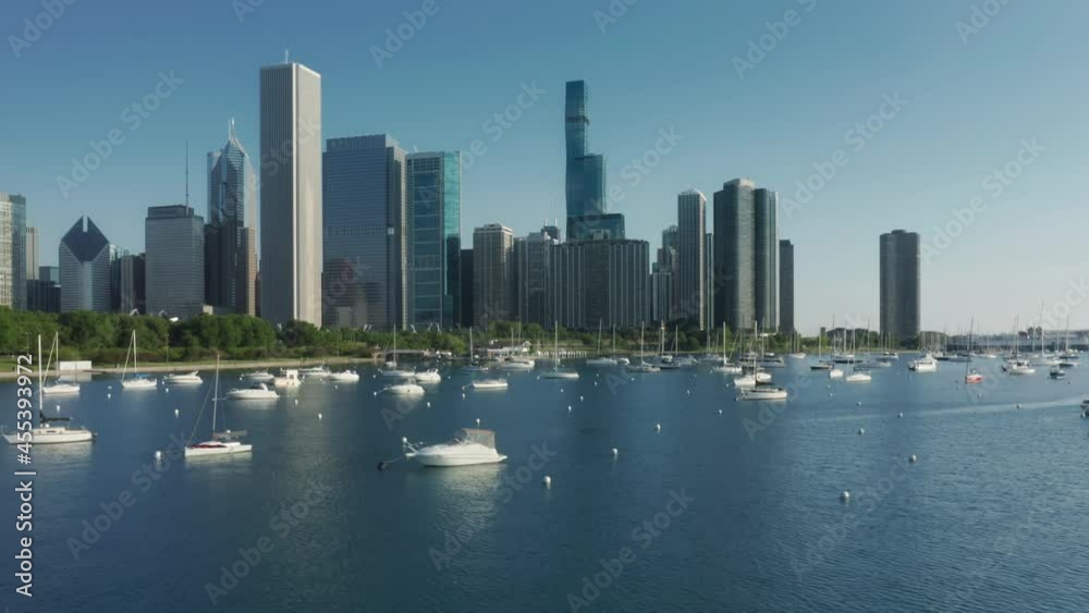 4K aerial USA travel business background. Illinois water tourism transport, panorama of blue lake waters in Chicago bay harbor. Residential front line buildings with beautiful marina on Michigan lake. 4K aerial USA travel business background. Illinois water tourism transport, panorama of blue lake waters in Chicago bay harbor. Residential front line buildings with beautiful marina on Michigan lake.