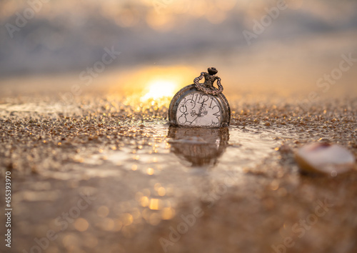Locket clock on beach background