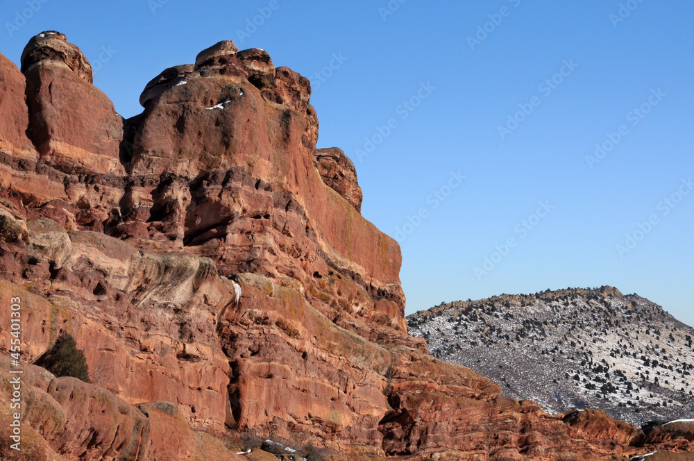 Sandstone geological formation at Red Rocks Park in Morrison Colorado with snow in foothills