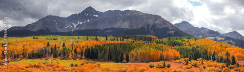 Panoramic view of Wilson peak in Colorado surrounded by Fall foliage in autumn time photo