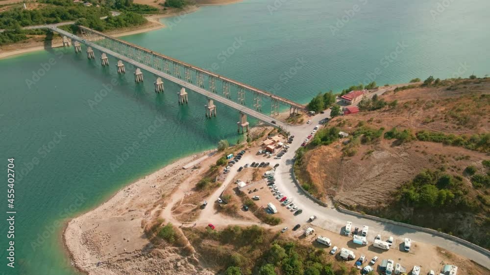 Top View Of Vacationists Campervan By The Lakeshore Of Campotosto With Bridge In Abruzzo, Italy. - Aerial