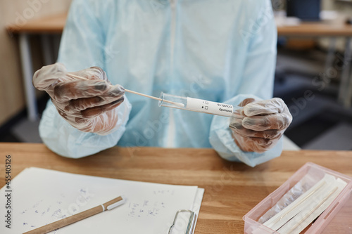 Fotomural Hands of physician in PPE suit putting swab with nose mucus of patient in test t