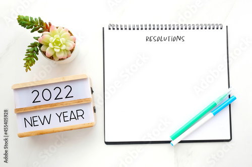 2022 new year on wood box, Resolution on blank notebook paper on white background, 2022 new year mock up, template, flat lay