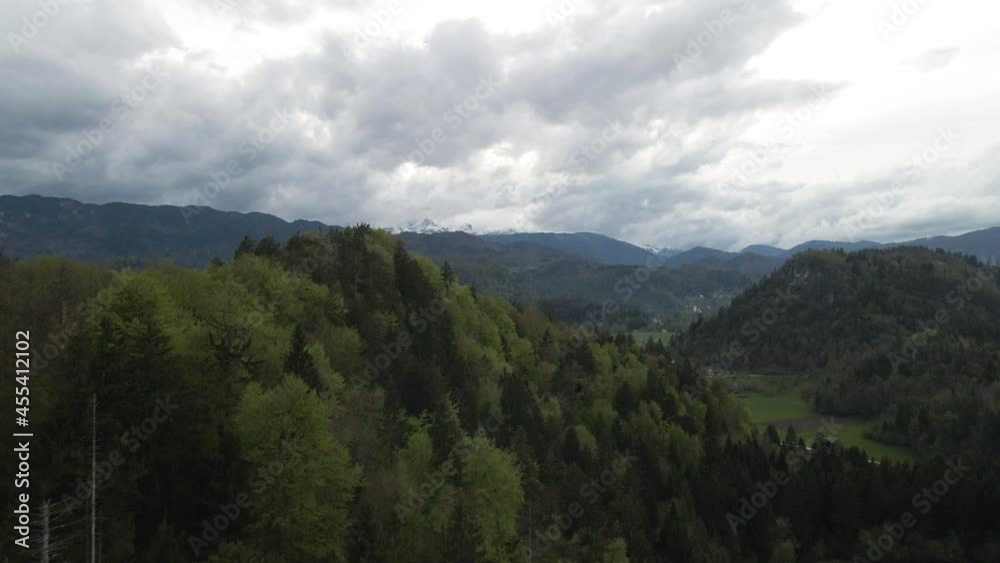 Alpine landscape reveal in Bled, Slovenia; moody sky, snow on mountain Alpine landscape reveal in Bled, Slovenia; moody sky, snow on mountain