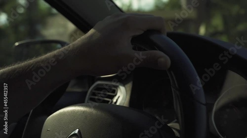 Moody car drive close up of the whee and beautiful back golden hour sunlight.
