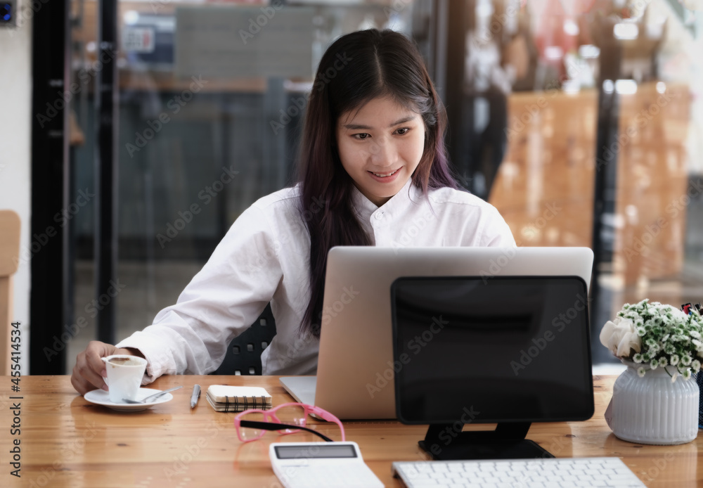 new normal, a businesswoman uses a computer to work for a company Via the internet on your desk at home. new normal, a businesswoman uses a computer to work for a company Via the internet on your desk at home.