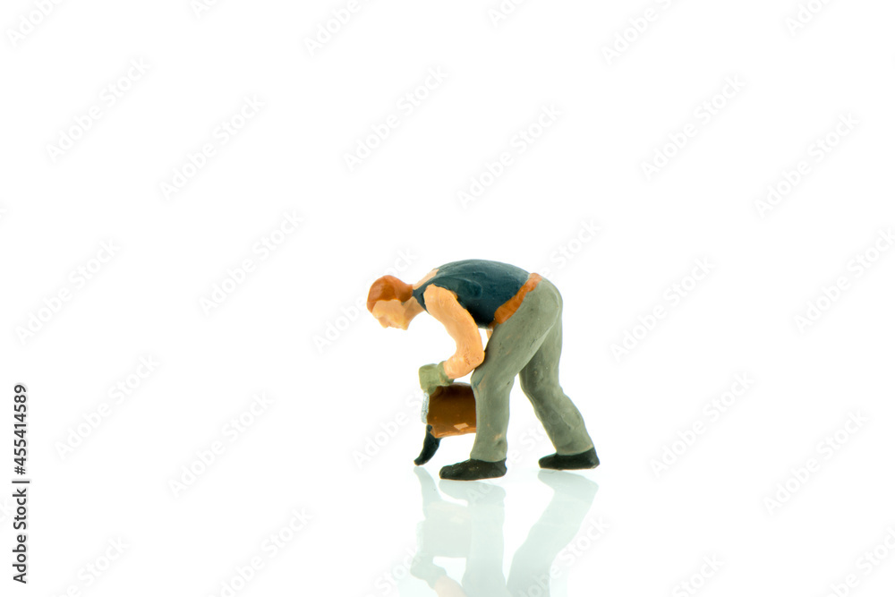 Miniature people cleaning up concept on white background with a space for text Miniature people cleaning up concept on white background with a space for text