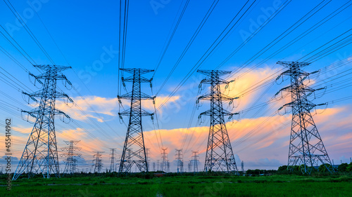 High voltage power tower industrial landscape at sunrise,urban power transmission lines.