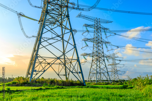 High voltage power tower industrial landscape at sunrise,urban power transmission lines.