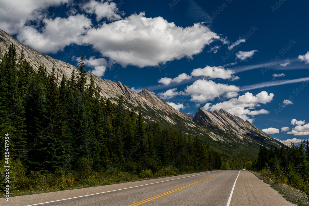 Road in a mountain valley. Canadian mountains, clouds.