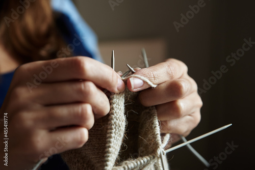 Woman knitting socks with needles