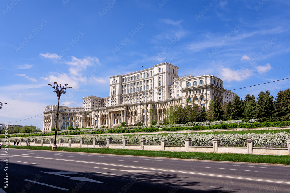 The Palace of the Parliament also known as People's House (Casa Popoprului) in Constitutiei Square (Piata Constitutiei) in Bucharest, Romania, in a sunny spring day.