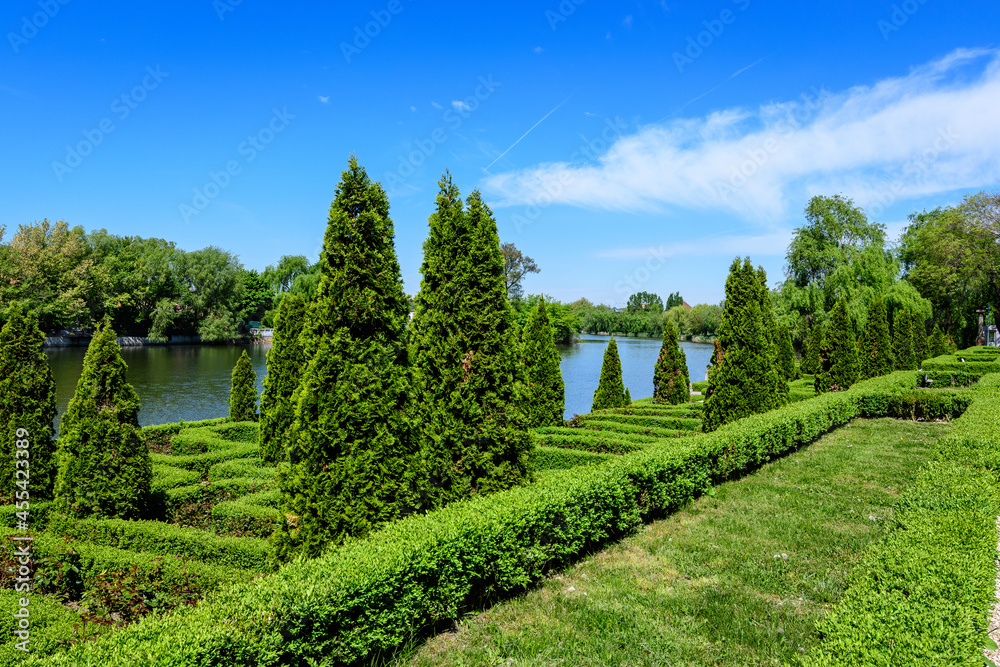 Landscape with old green trees near Mogosoaia lake and park, a weekend attraction close to Bucharest, Romania, in a sunny spring day