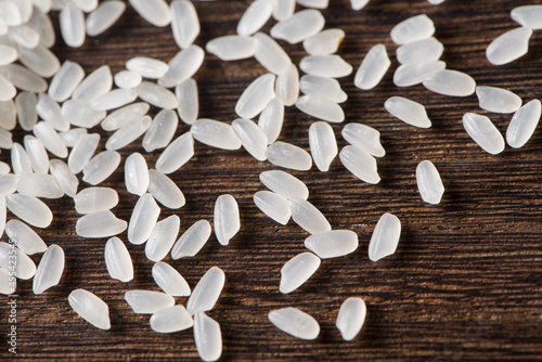 close up of raw white rice on wooden background