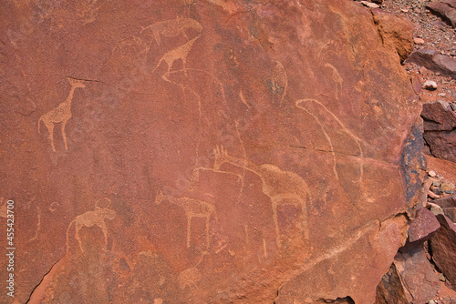 Site of ancient petroglyphs. Carved with giraffes, horses and other animals. photo