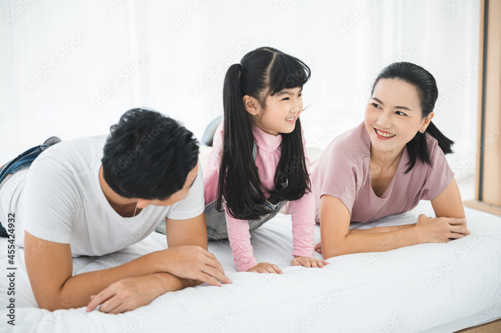 Asian children family with father and mother at home, little girl childhood development education concept, happy young cute daughter having fun to learning with eltern family at home Asian children family with father and mother at home, little girl childhood development education concept, happy young cute daughter having fun to learning with eltern family at home
