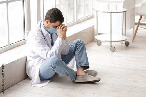 Religious doctor praying in...
