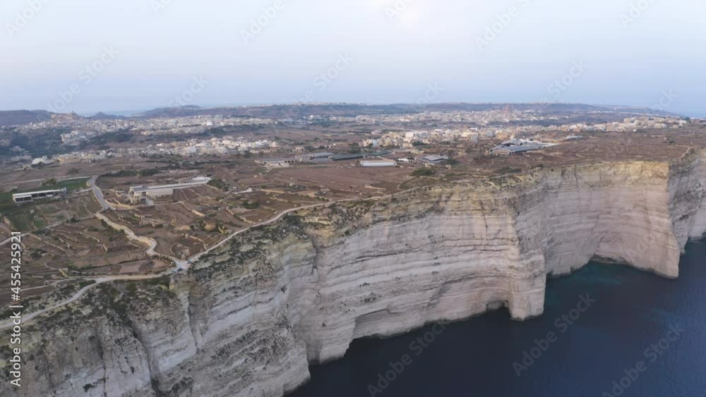 City on the edge of coastal cliffs of Gozo island,Malta,aerial shot. City on the edge of coastal cliffs of Gozo island,Malta,aerial shot.