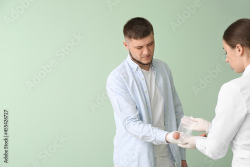 Doctor applying bandage ont...