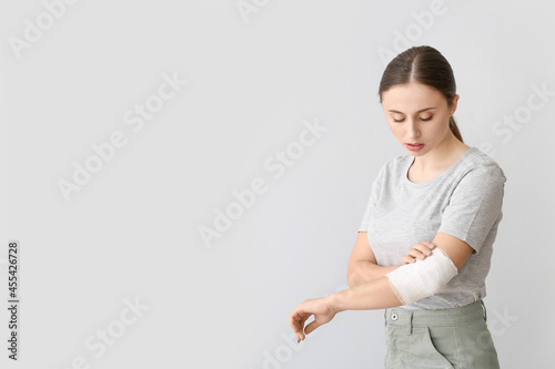 Young woman with bandaged a...
