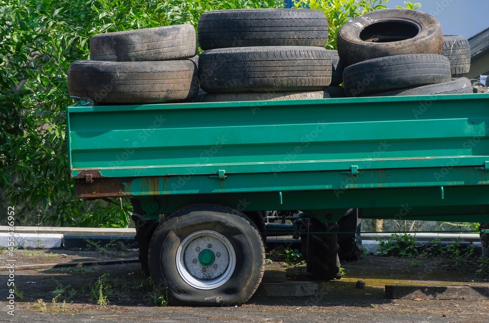 Pile of used tires in a pickup truck with a flat tire Pile of used tires in a pickup truck with a flat tire