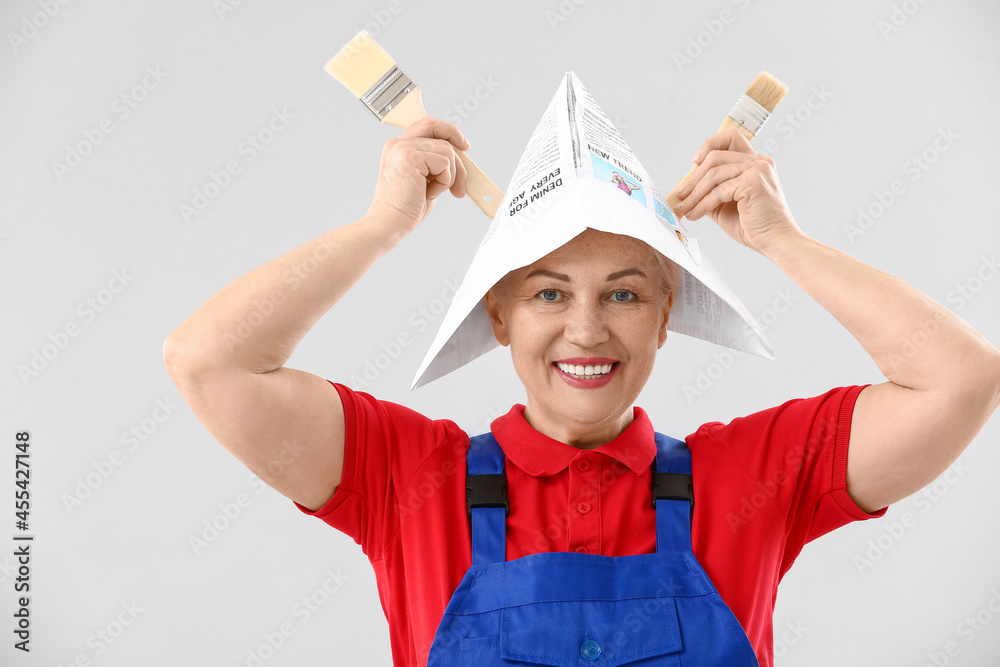 Female painter with brushes on light background Female painter with brushes on light background