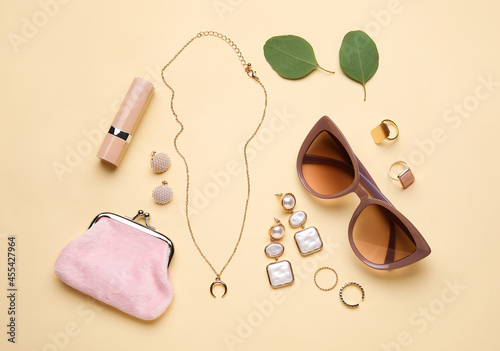 Set of female accessories on color background