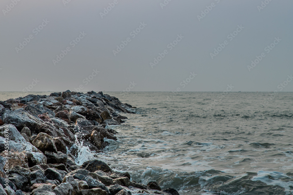 Rocks and sea : View of sea waves hitting rocks on the Calm beach in the morning. No focus, specifically.