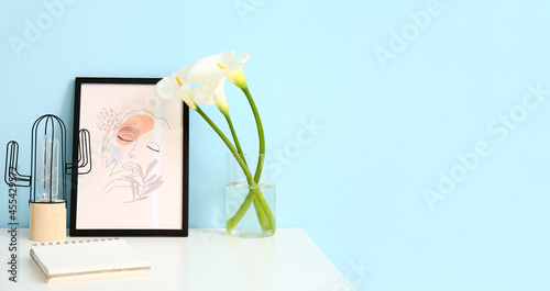 Vase with flowers and pictu...