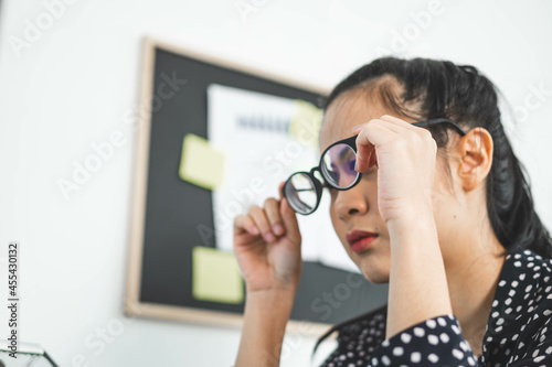 Fototapeta Naklejka Na Ścianę i Meble -  Young woman taking off glasses tired of computer work, exhausted student or employee suffering from eye strain tension or computer blurry vision problem after long laptop use, eyes fatigue concept