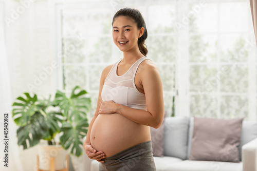 Happy Pregnant Woman standing in front of windows and stroking big belly with love at cozy home,Pregnancy of young woman enjoy with future life,Motherhood and Pregnant Concept Free Download Happy Pregnant Woman standing in front of windows and stroking big belly with love at cozy home,Pregnancy of young woman enjoy with future life,Motherhood and Pregnant Concept - GFXLoad