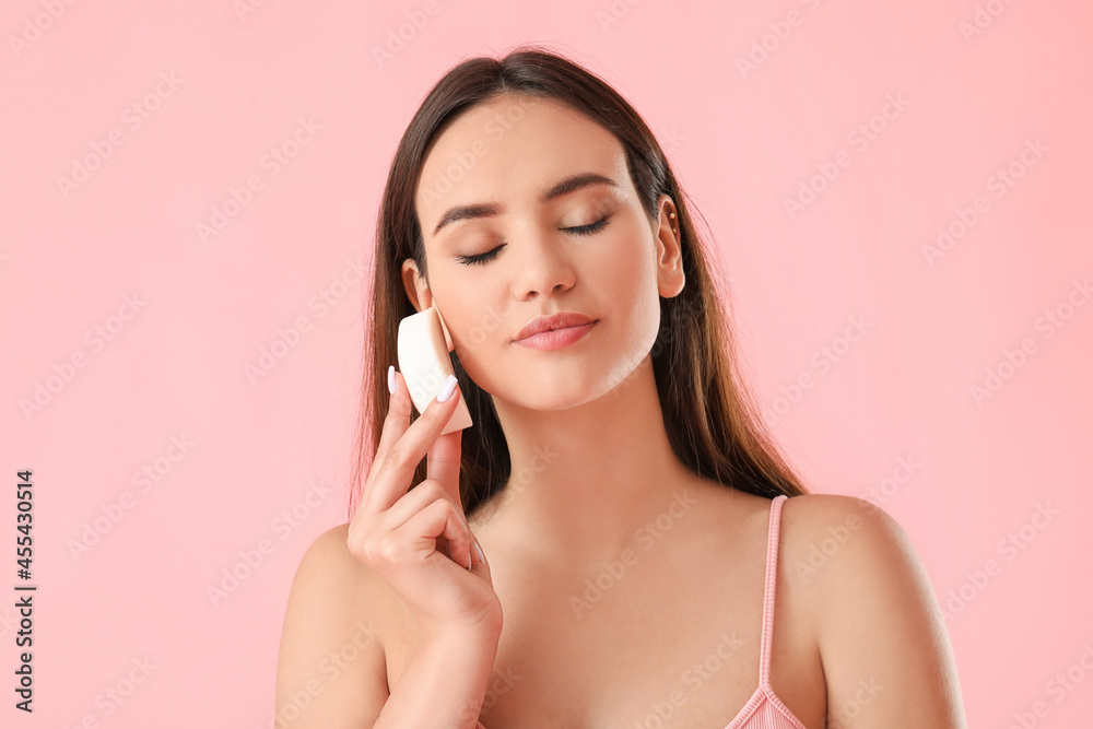 Beautiful young woman with soap on color background